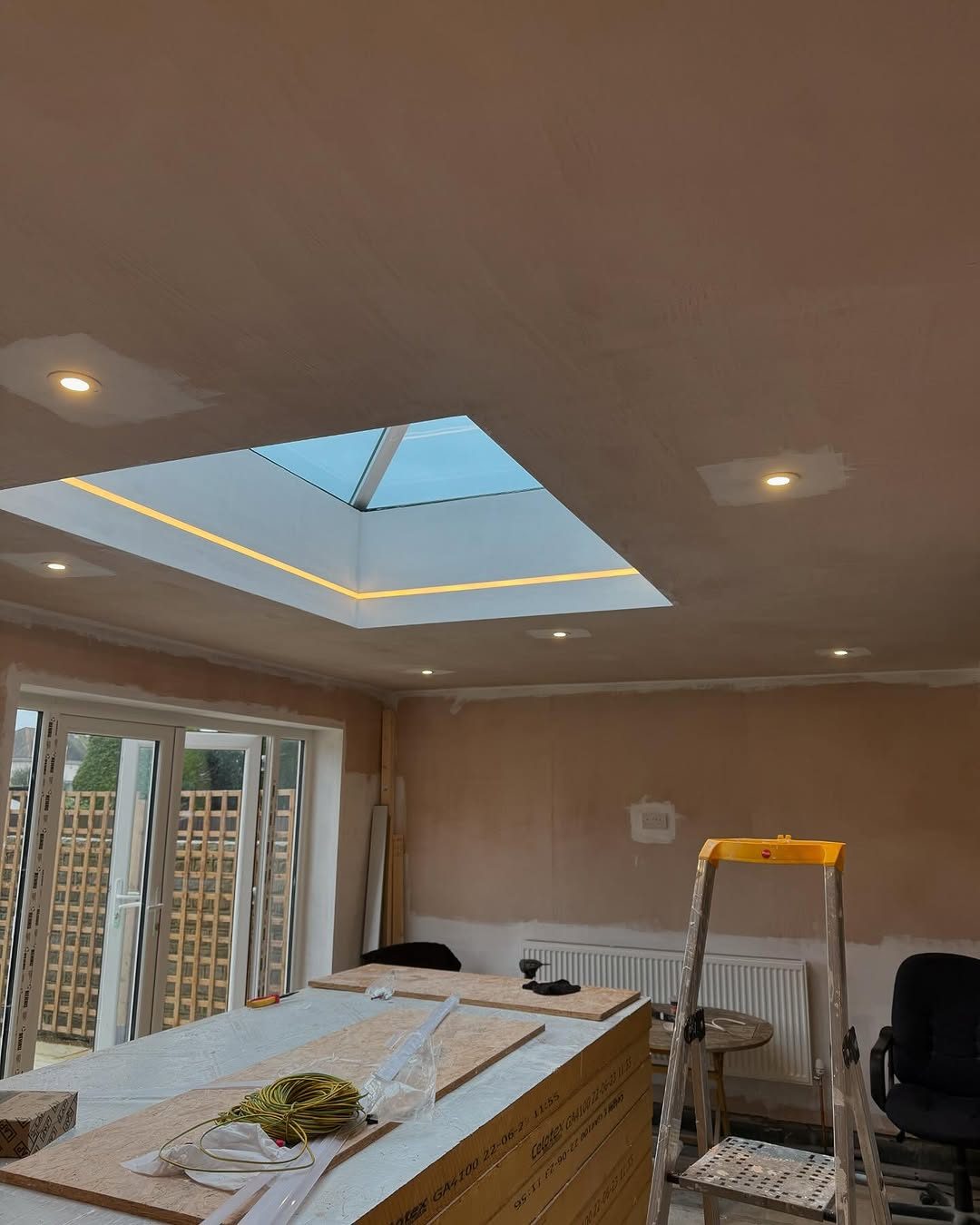 A room mid-rewire with new downlights and fresh plaster, by Snelling Electrical